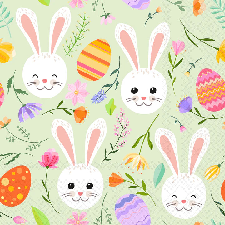 Cocktail napkins with a pattern of Easter bunnies and eggs on a green background