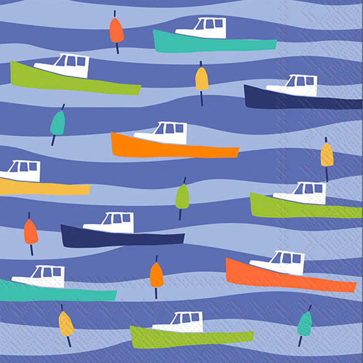 A patterned cocktail napkin featuring colorful illustrations of lobster boats on a blue wavy background.
