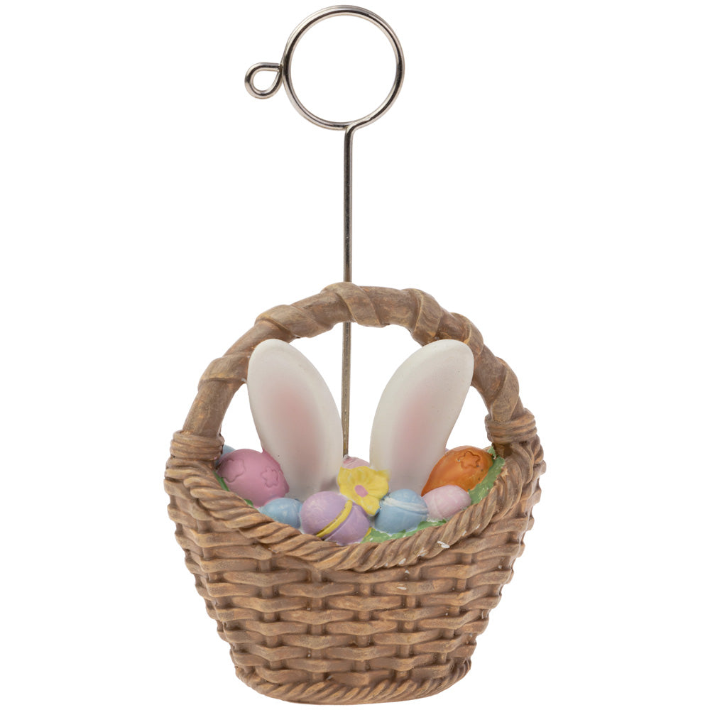 A resin placecard holder in the shape of a basket with a playful design featuring bunny ears and Easter eggs.
