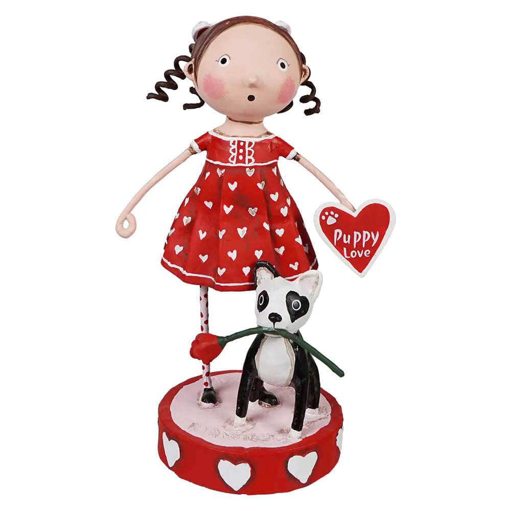 A figurine of a girl in a red dress with hearts holding a panda bear with a 'Puppy Love' tag, standing on a round base with heart designs.