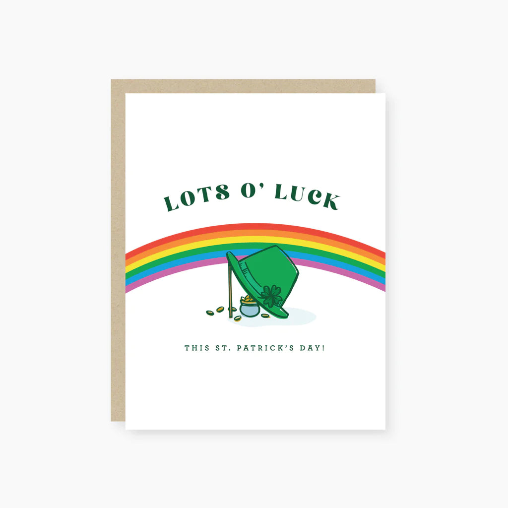 A greeting card with a cartoon illustration of a leprechaun, a pot of gold, and a rainbow, with 'Lots O'Luck' and 'This St. Patrick's Day!' text, accented with gold foil.