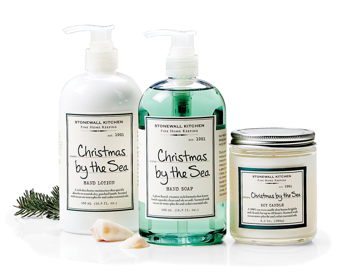 Photo shows the Stonewall Kitchen Christmas by the Sea collection, including 1 bottle of hand soap, 1 bottle of shea butter moisturizing Hand Lotion, and 1 Christmas by the Sea Candle 6.5 oz. jar