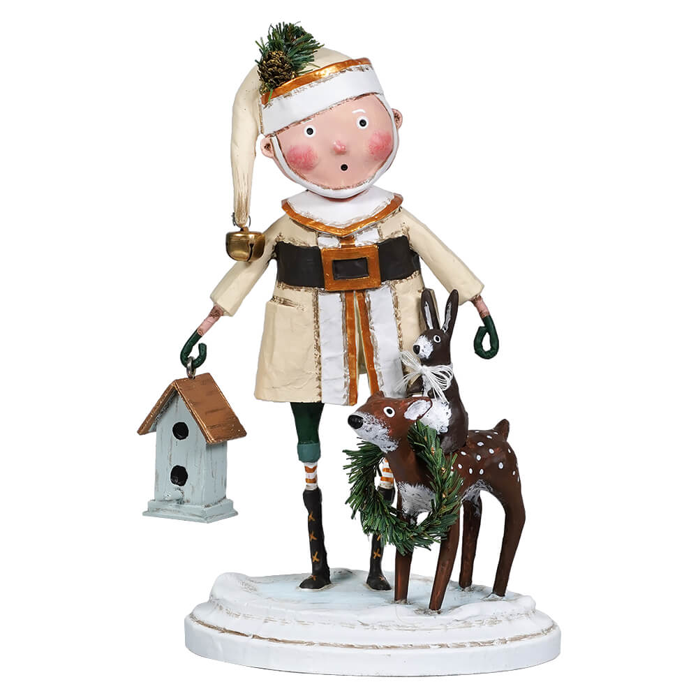 A whimsical figurine of Santa Claus wearing a green hat and a beige coat with brown fur, holding a blue birdhouse, and accompanied by a reindeer. The reindeer has a green and white color scheme with a bow on its head.