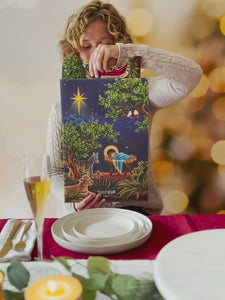 A video showing a young woman opening and admiring the FreshCut Paper Starlit Nativity Pop-Up Christmas Decoration